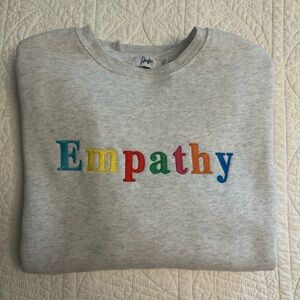 The Mayfair Group — “Empathy Always” grey crewneck